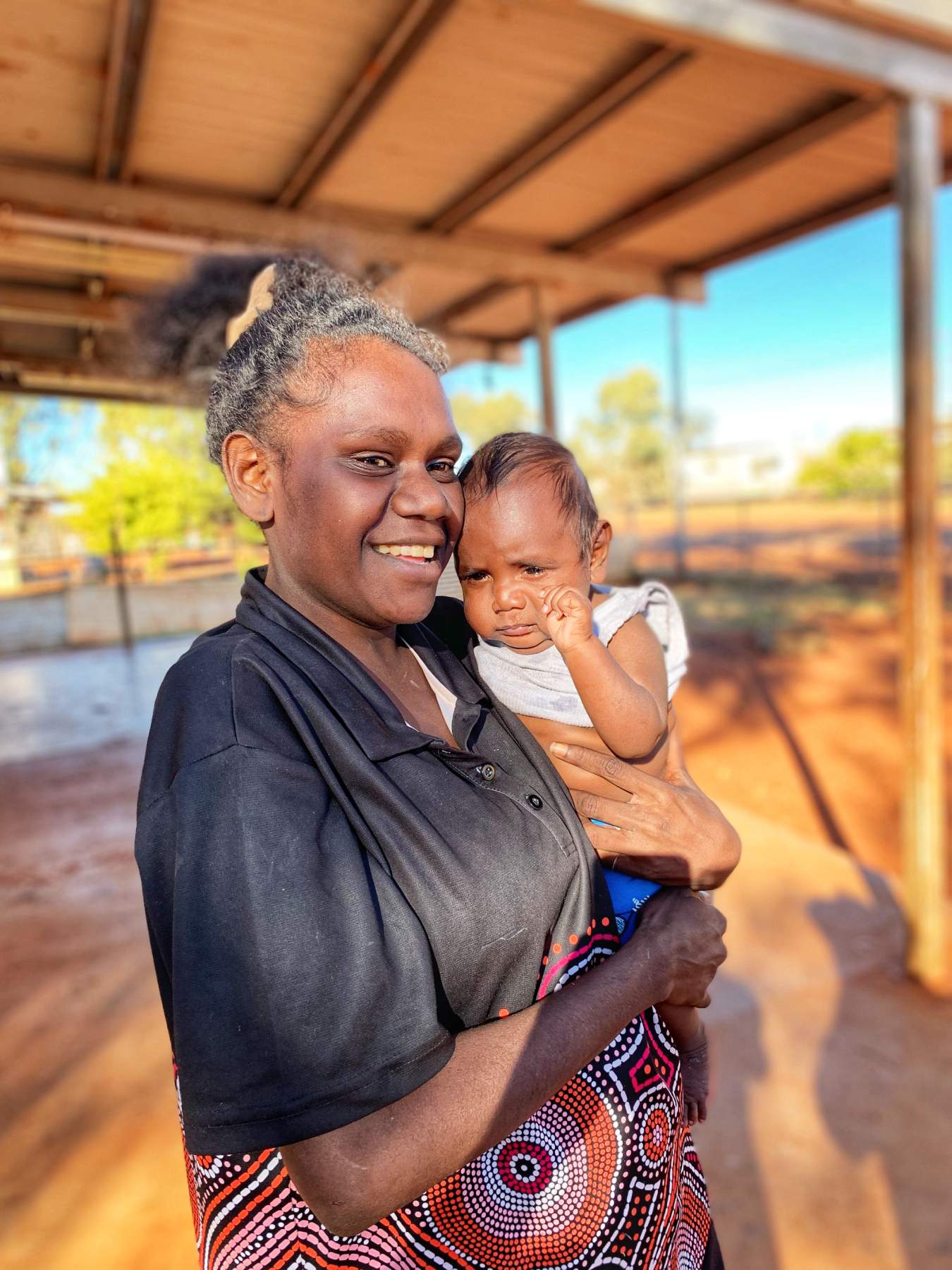 A woman holding her son.