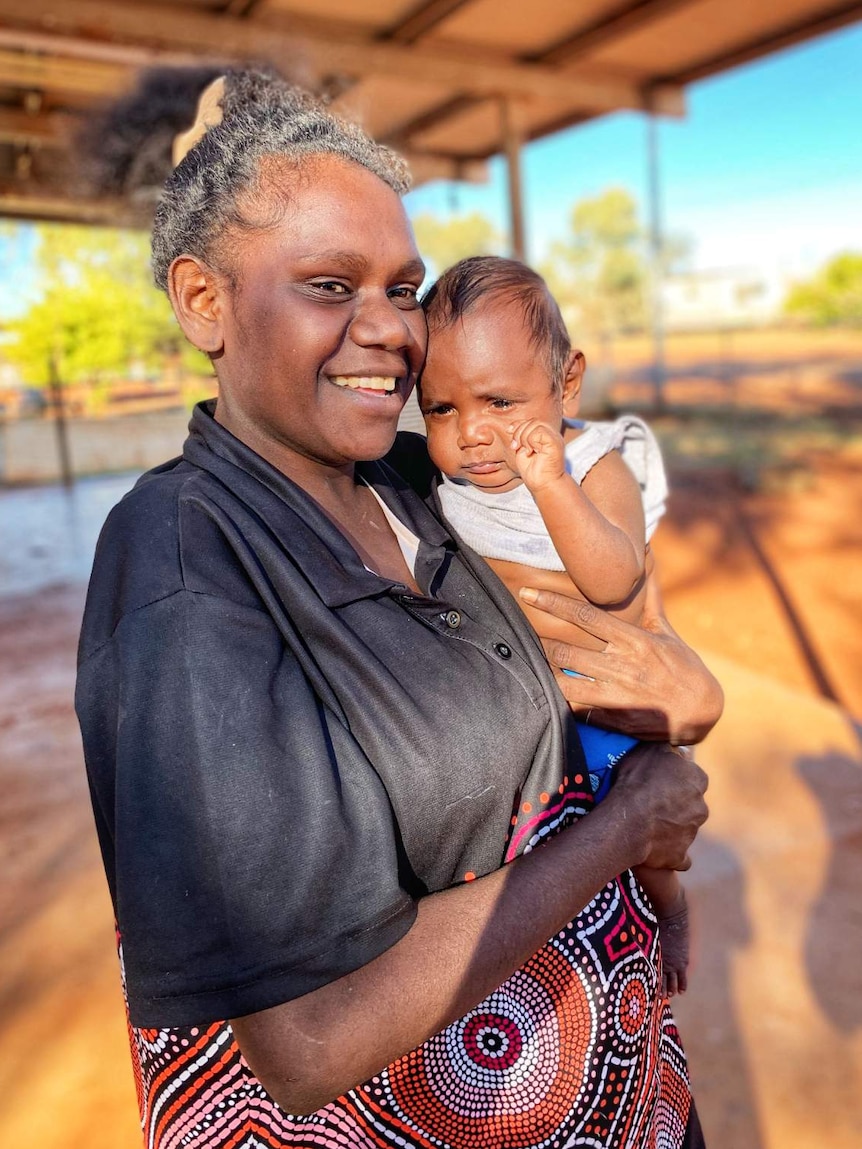 A woman holding her son.