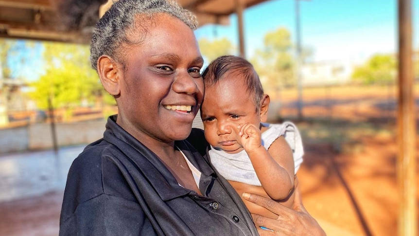 A woman holding her son.