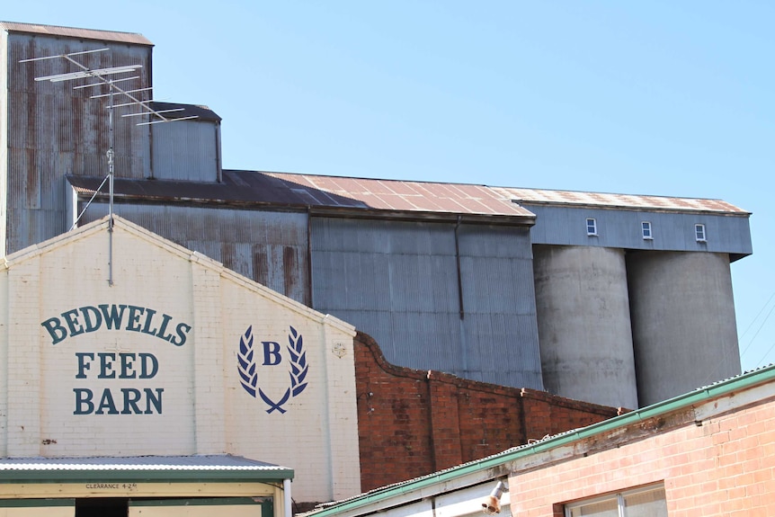 An external shot of a mill, with brick and corrugated iron buildings.
