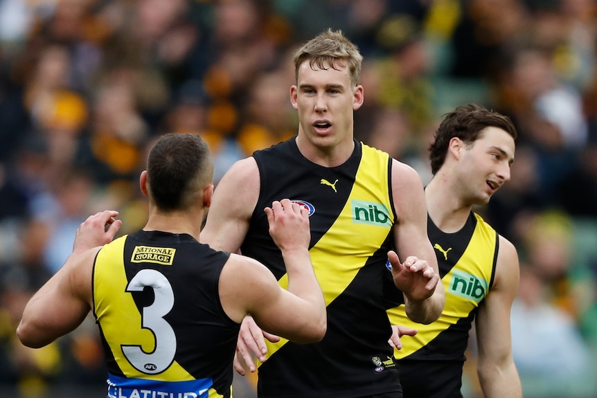 Tom Lynch is congratulated by Richmond teammates