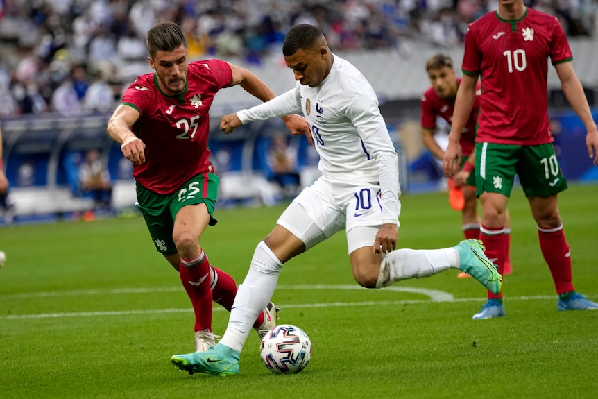 Kylian Mbappe fights for the ball