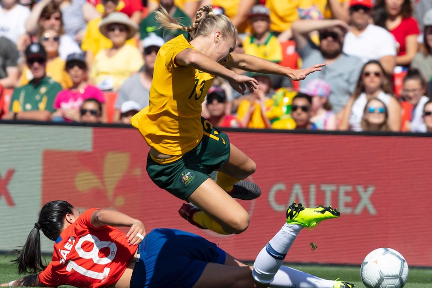 Tameka Butt jumps to avoid a Chilean tackle.