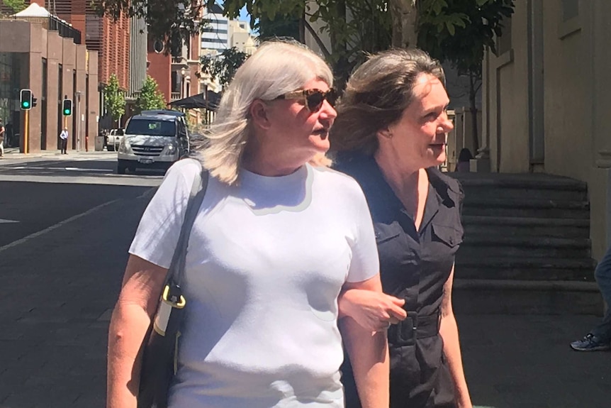 Two women standing outside a court house in Perth's CBD.