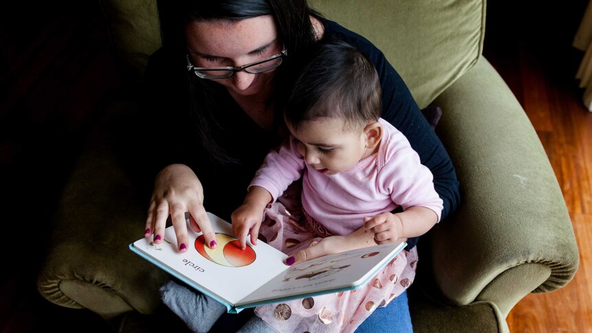 Rachael and her daughter Zara read together.