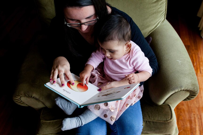 Rachael and her daughter Zara read together.