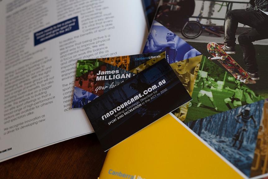 A product photo shows business cards and pamphlets with Canberra Liberals branding.
