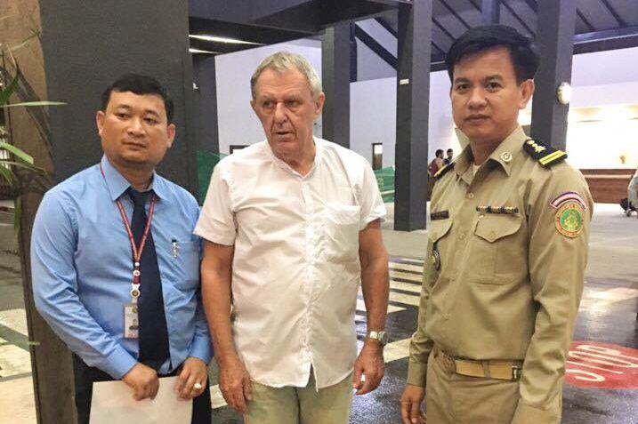 Fugitive Australian Guido James Eglitis (centre) with Cambodian officials in 2015