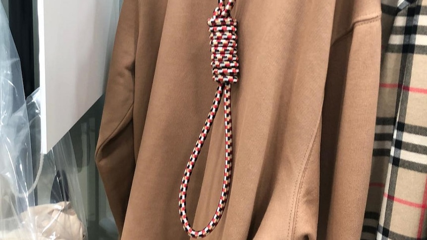 A brown hooded jumper with a noose hanging from the hood.