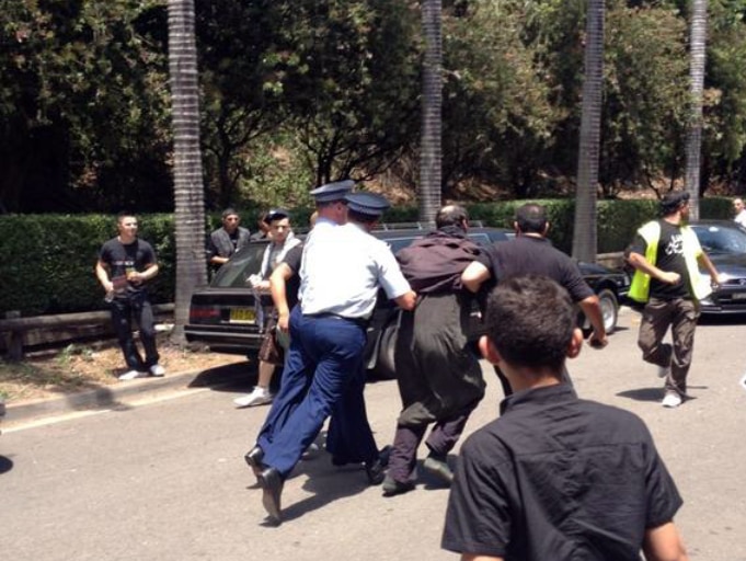 Police restrain one of two men who were arrested after an incident at Arncliffe Mosque.