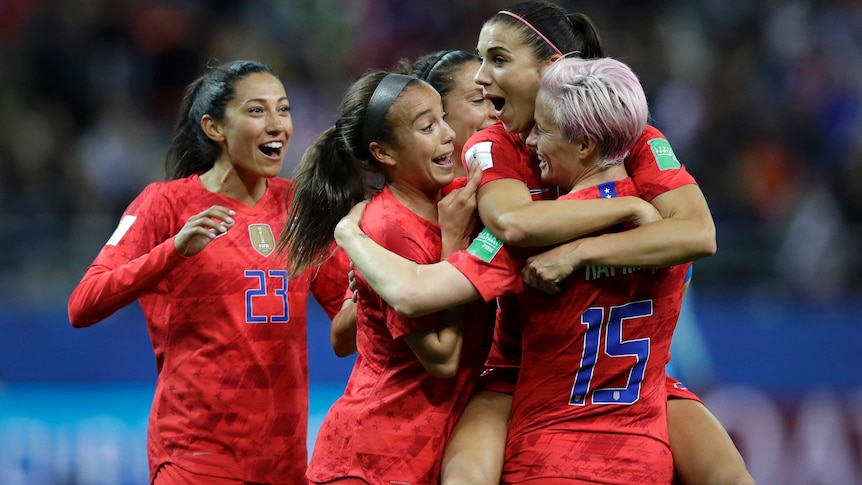 Alex Morgan is surrounded by her teammates