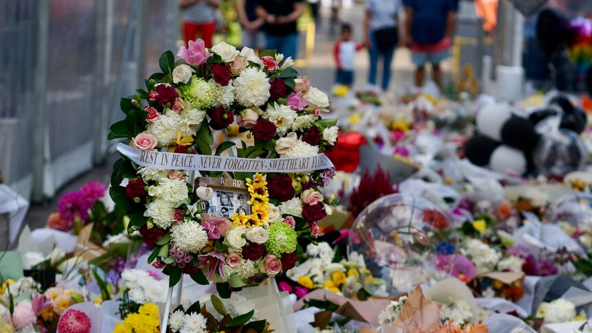 A large floral tribute to those who died in the Bondi Junction mass stabbing.