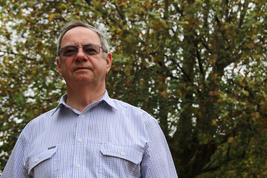 Head and shoulders shot of Allan Lowe with a tree backdrop.