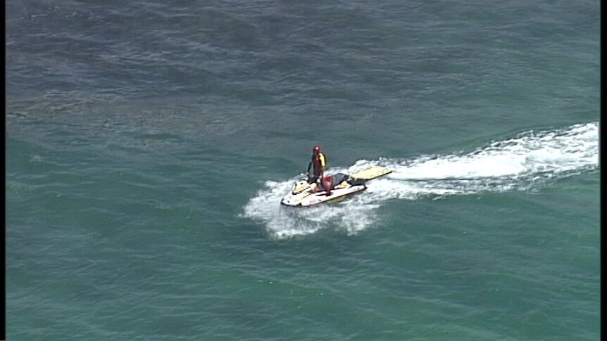 A surf lifesaver on a jetski searches for a missing bodyboarder off Fingal Head in northern New South Wales.
