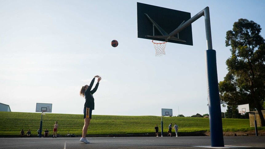 Zoe playing basketball at a local court.