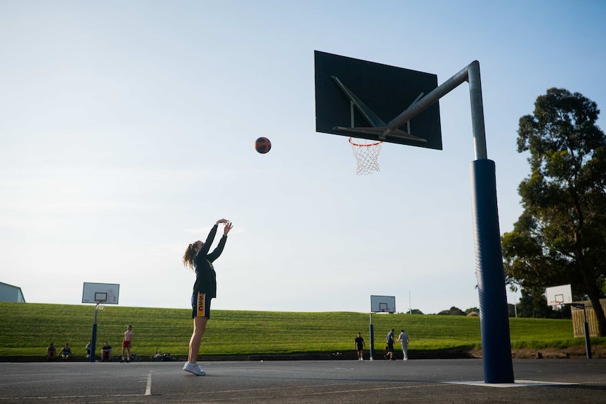 Zoe playing basketball at a local court.