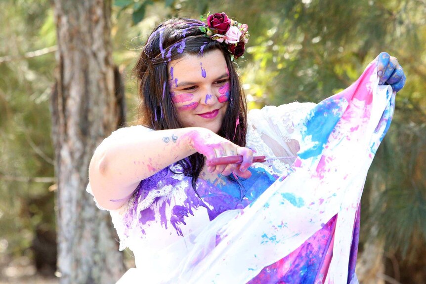 Kira Coleman cuts her wedding dress already ruined in paint