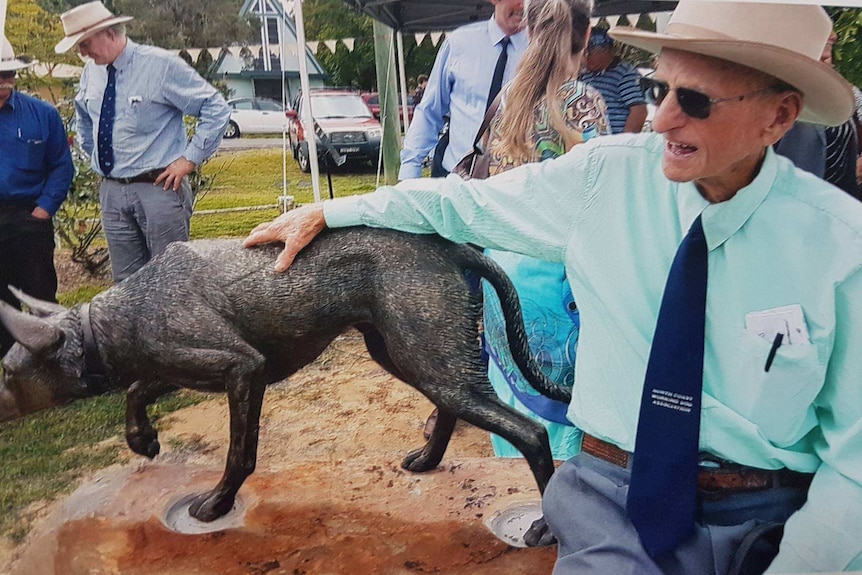 Frasey Ramsey with a bronze working dog statue.