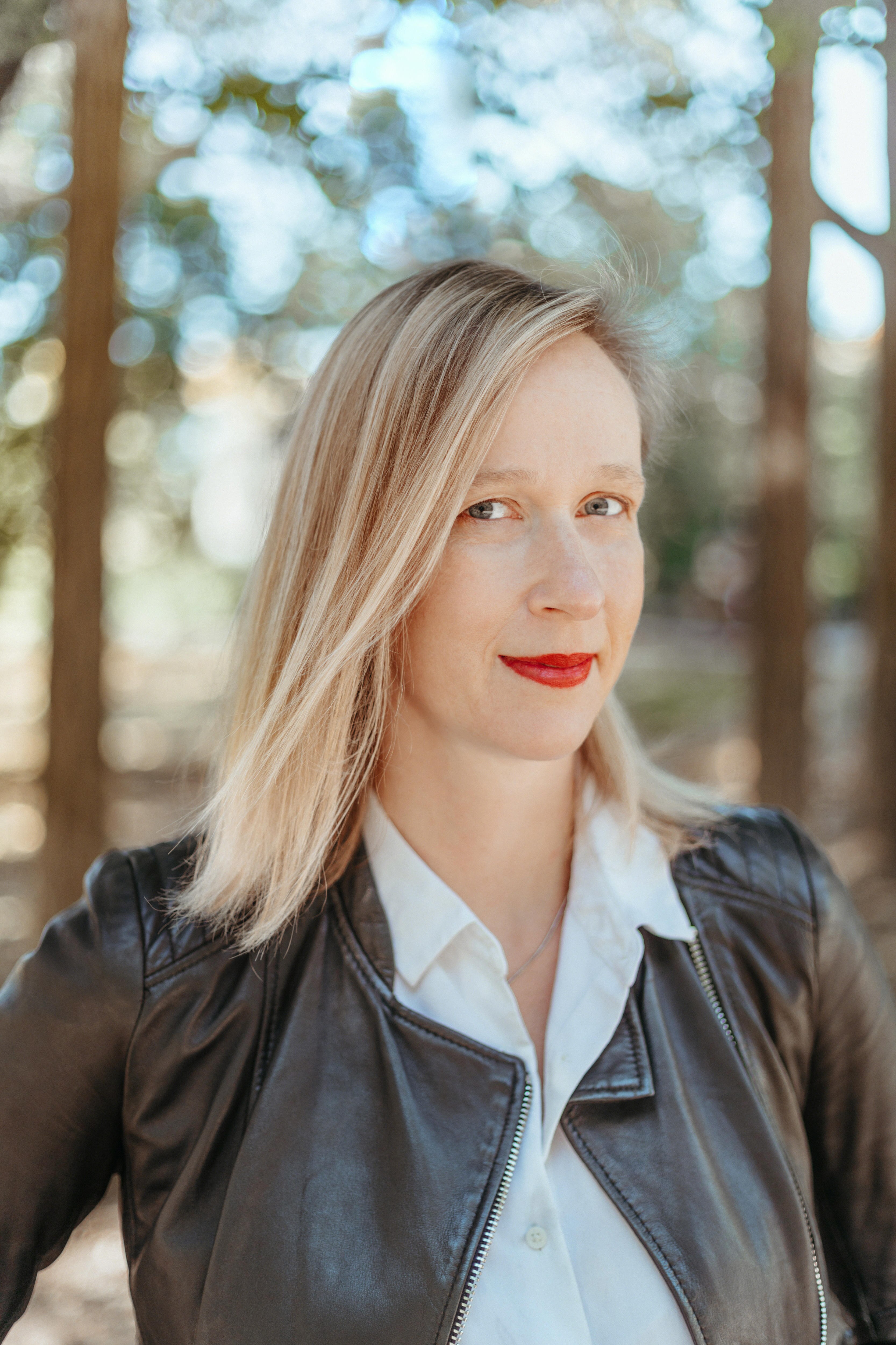 Woman in a forest smiling at camera