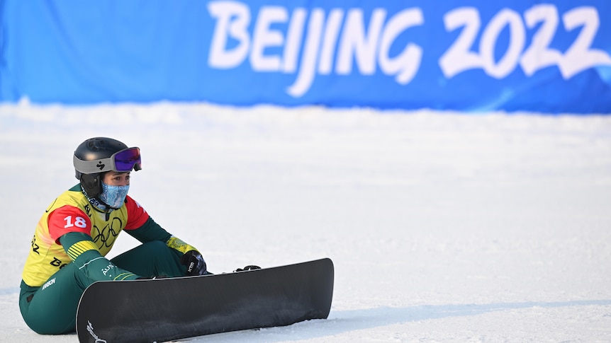 Belle Brockhoff sitting on the snow after the final of the women’s snowboard cross at the Beijing Olympics