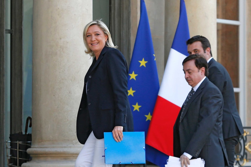 Marine Le Pen arrives at the Elysee Palace in Paris with National Front vice presidents in 2014.