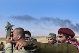 Libyan rebels gather outside the eastern oil town of Brega.