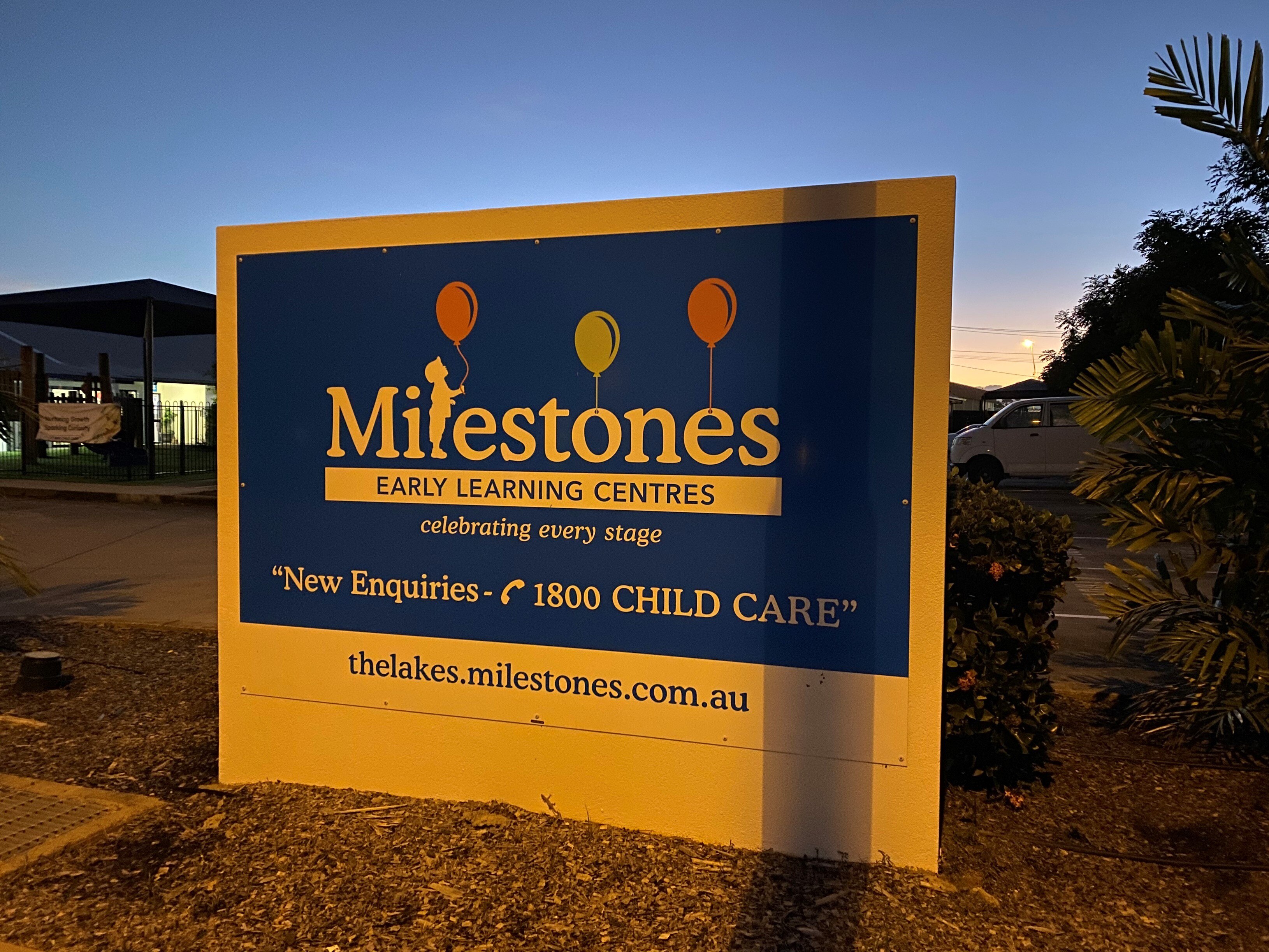 A sign for the daycare centre at dusk.