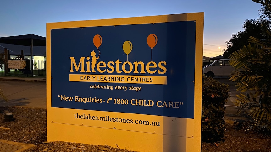 A sign for the daycare centre at dusk.