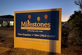 A sign for the daycare centre at dusk.