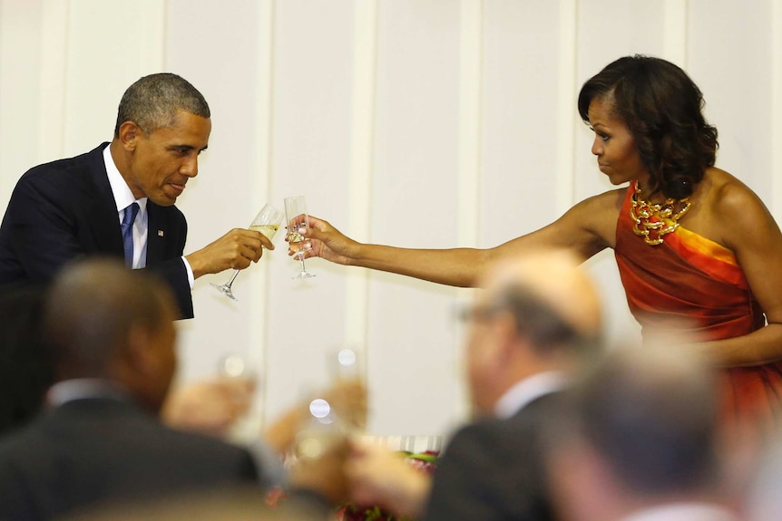 U.S. President Barack Obama toasts with first lady Michelle Obama during an official dinner with South African President Jacob Zuma (unseen) at the presidential guest house in Pretoria