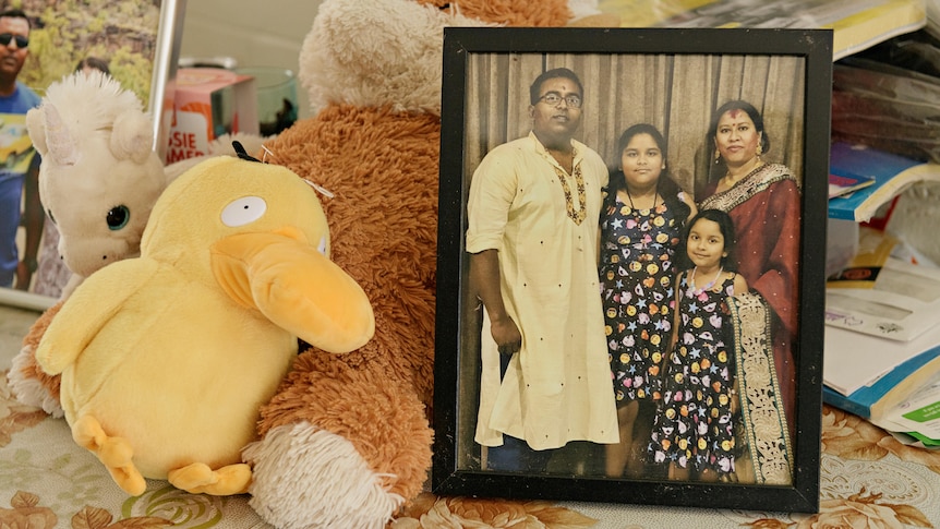 A picture of a family in a picture frame.
