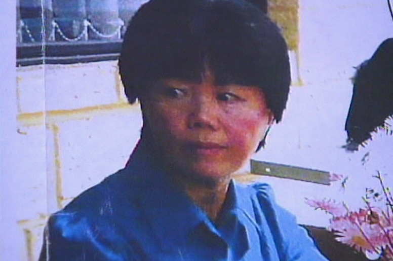 A head and shoulders shot of Ah Bee Mack wearing a blue shirt with short black hair.