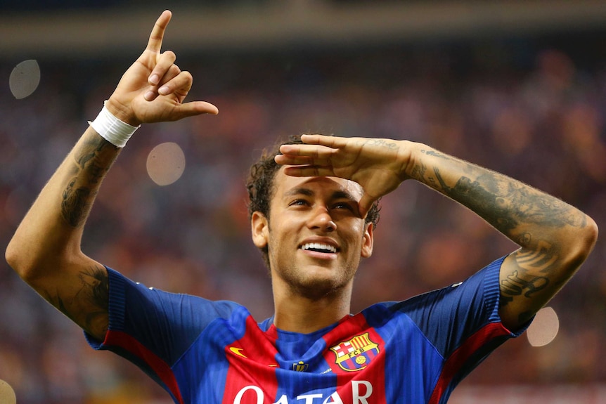 Neymar, while playing for Barcelona, celebrates a win by gesturing to the crowd.