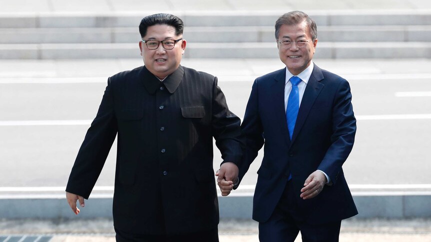 Kim Jong-un and Moon Jae-in cross the military demarcation line.