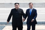 Kim Jong-un and Moon Jae-in cross the military demarcation line.