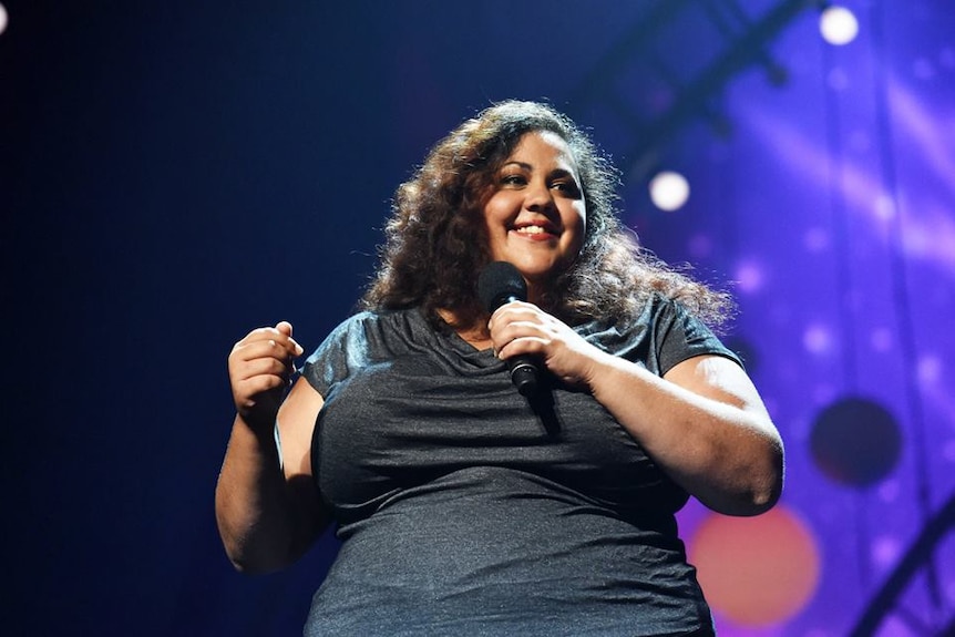 Comedian Steph Tisdell on stage performing at the Melbourne International Comedy Fest.