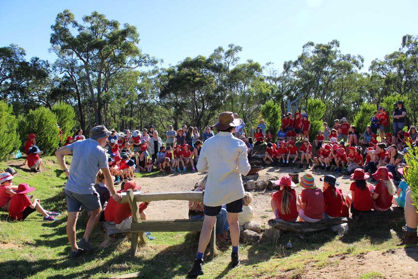 Students sit outdoors in a circle at Upper Sturt Primary.
