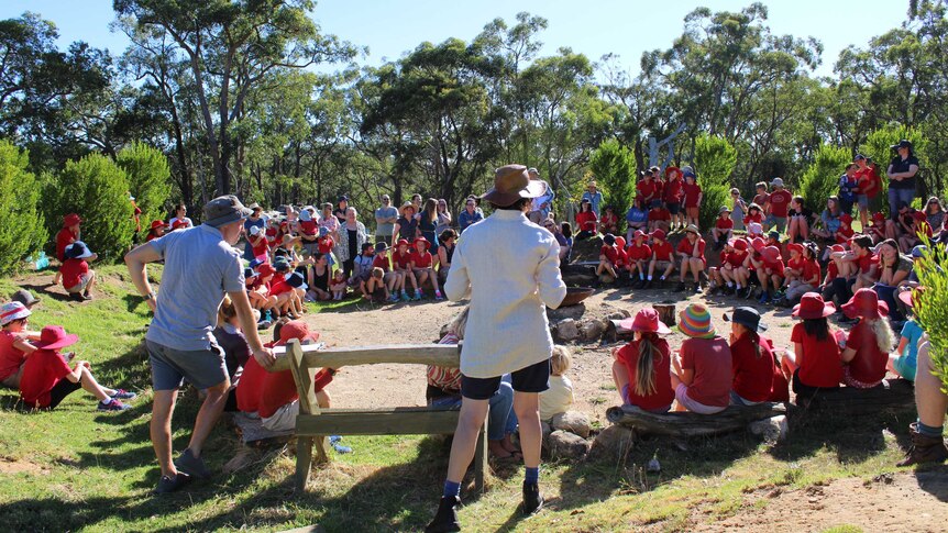 Students sit outdoors in a circle at Upper Sturt Primary.