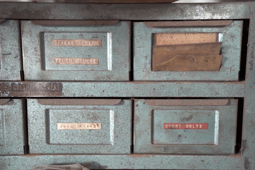 Four worn metal drawers