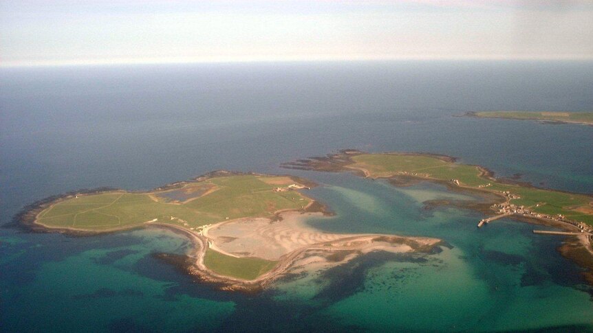An aerial shot of a three Scottish islands, taken on a clear day.