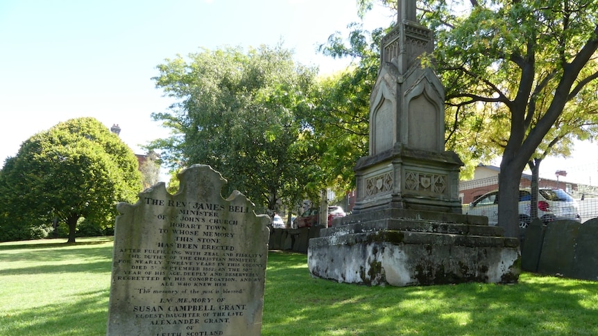 A tombstone and mausoleum in the green surrounds of North Hobart cemetery.