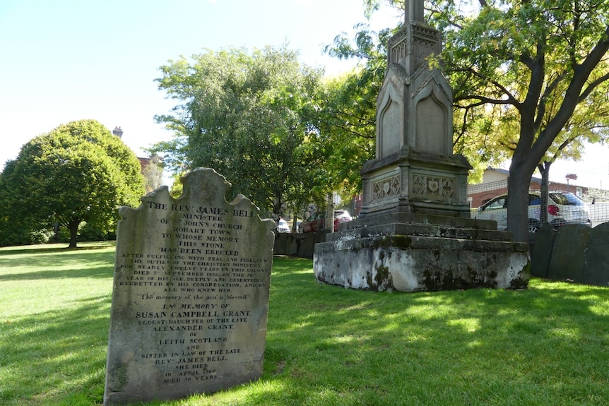 A tombstone and mausoleum in the green surrounds of North Hobart cemetery.