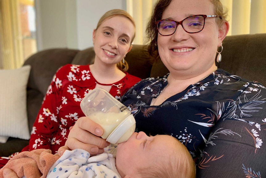 Couple Rebecca and Isabelle Sutherland holding their baby