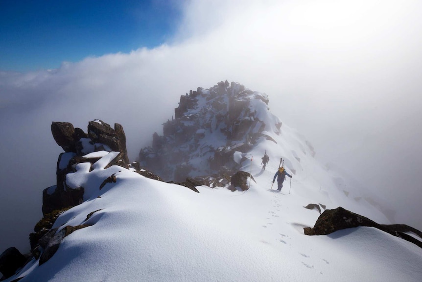 Skiers climb on Cradle Mountain