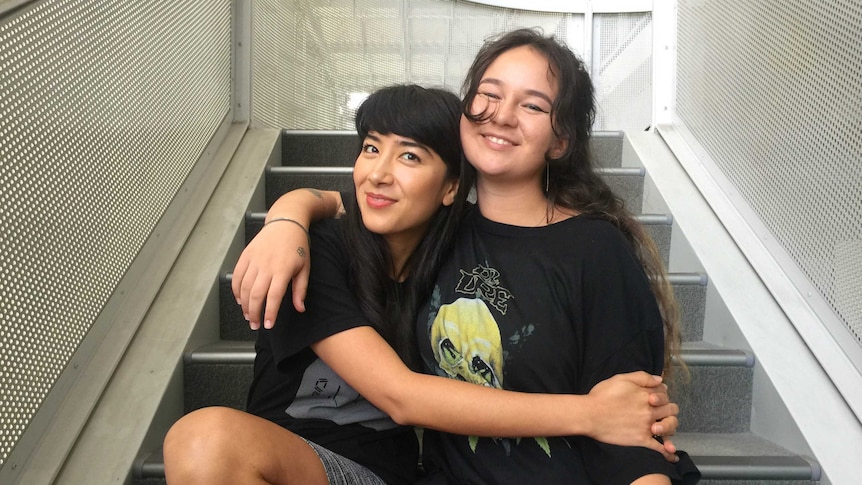 Linda and Mallrat sitting on the stairs hugging