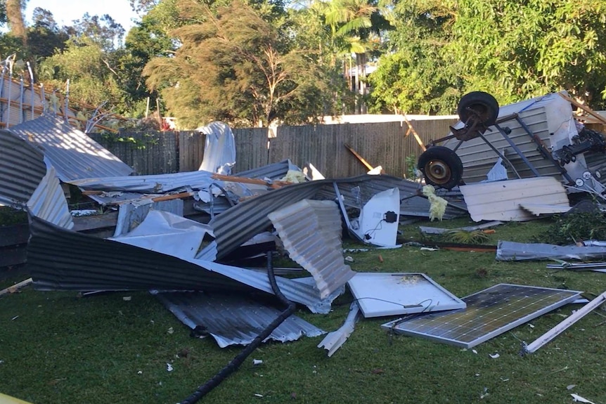 A yard strewn with debris after a storm