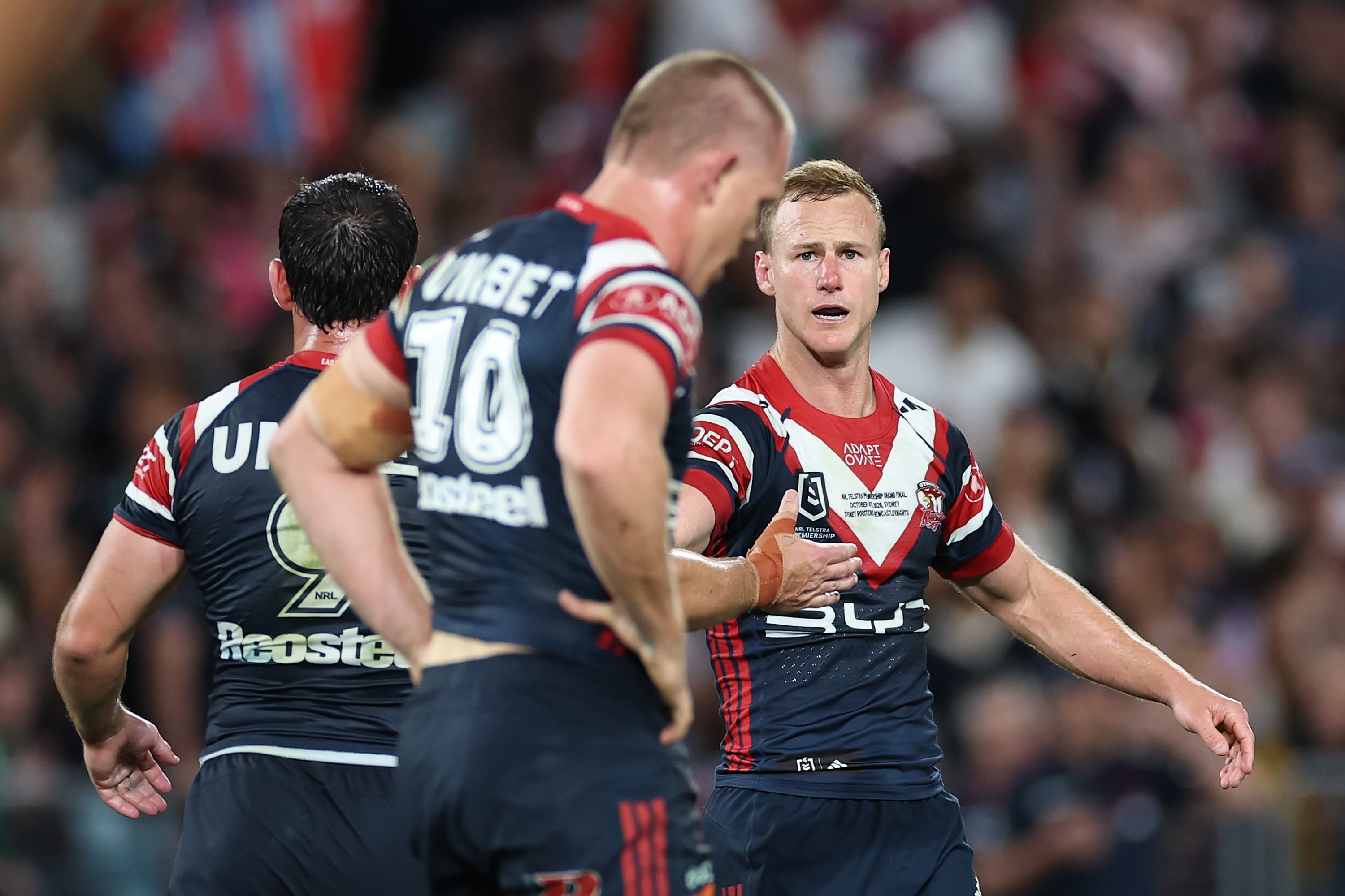 Daly Cherry-Evans high fives Sydney Roosters teammates.
