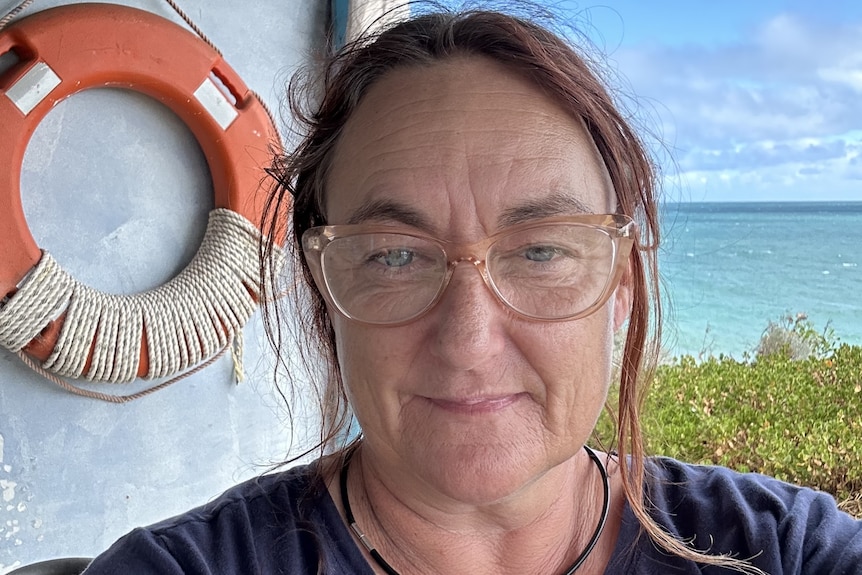 Close up of woman with ocean in the background