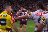 Jarome Luai reaches out to touch judge Chris Sutton to apologise for pushing him during an NRL match.