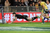 New Zealand's Beauden Barrett scores a try, chased by Australia's Reece Hodge, in the Bledisloe Cup.